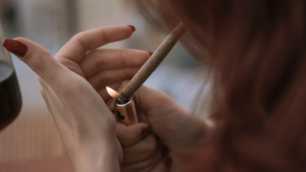 Woman lighting up a joint.