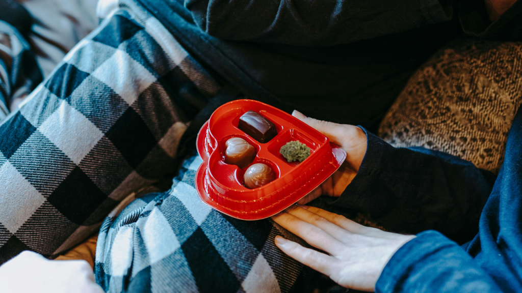 Heart-shaped box with cannabis chocolates and a nug, offering a creative Valentine’s Day gift idea.